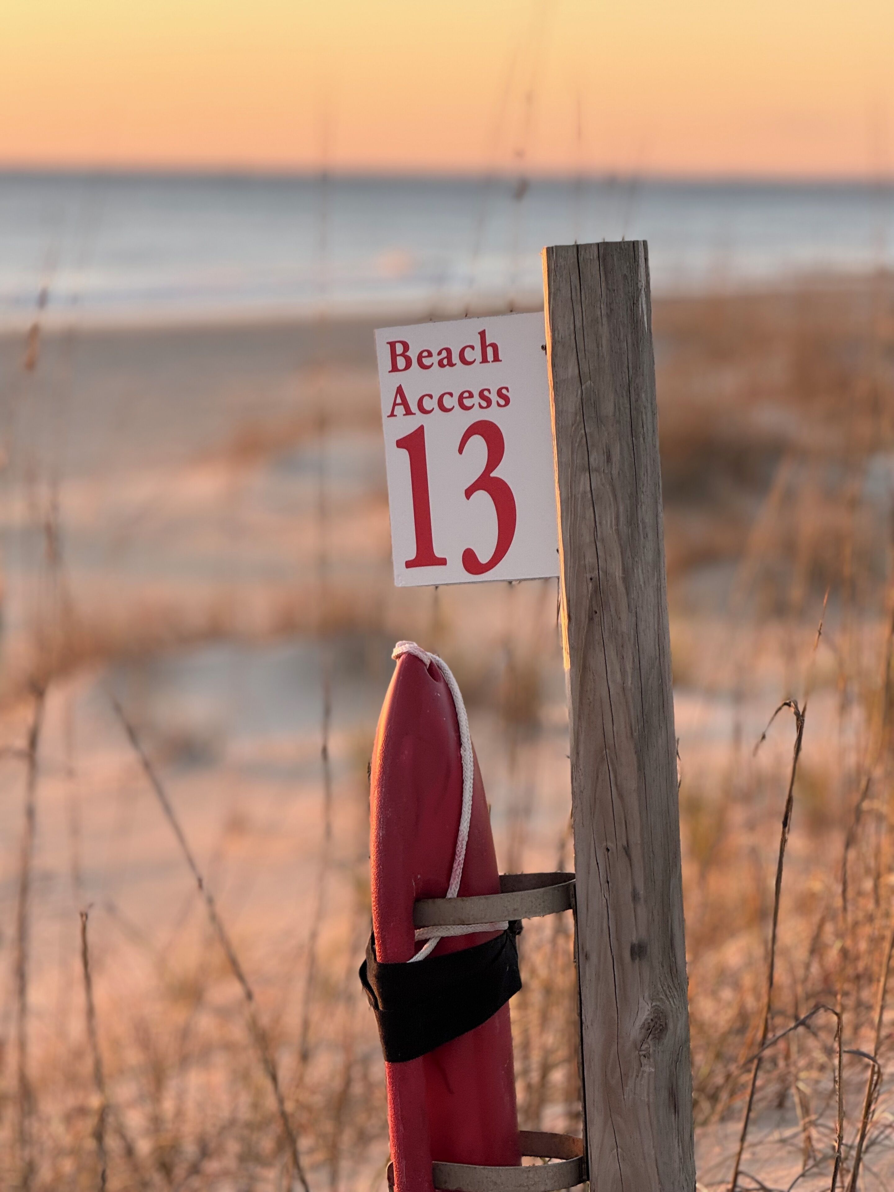 A beach access sign with the number 13.