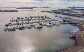 Stroll along the marina's walkway and enjoy the serene views of the boats docked in the calm waters.