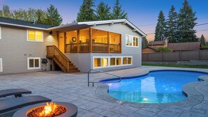 A two-story house with a covered patio, a swimming pool, and a fire pit. - Luxury 8 beds Villa with Pool & Resort Amenities (Edmonds)