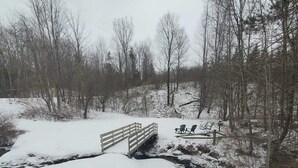 A wooden bridge over a snow-covered stream in a forested area. - Week/ Weekend Cabin Rental #2 (Luther)