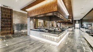 A modern kitchen with a central island, marble flooring, and a wooden ceiling design. - Jeonju The May Hotel (Jeonju)