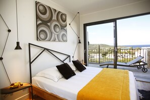 Relax in this serene bedroom with a single bed, black metal frame, and minimalist decor, featuring a large abstract artwork and sliding glass door to a balcony.