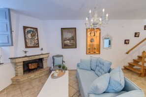 Luxury Apartment | Living area | 50-inch Smart TV with cable channels, TV, fireplace