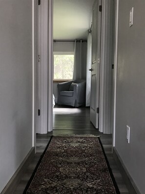 Enter a cozy space with a large window and a comfortable chair.