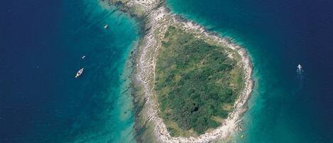 Escape to a serene tropical island surrounded by crystal-clear waters and a lush, verdant interior.