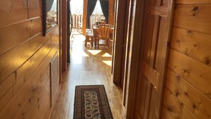 A wooden interior with a hallway leading to a dining area. - Spectacular Mountain View is Yours to Enjoy (Sevierville)