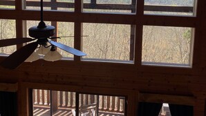 A room with large windows offering a view of a forested mountain range. - Spectacular Mountain View is Yours to Enjoy (Sevierville)