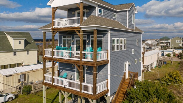 A two-story house with a balcony and a deck. - Gorgeous Ocean and Sound Views Await at Good Better Beach! (North Topsail Beach)