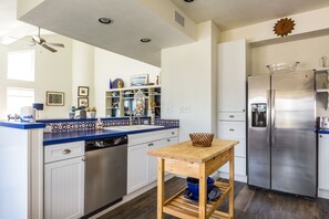 Enjoy cooking in this well-equipped kitchen with a refrigerator, dishwasher, and ample workspace.