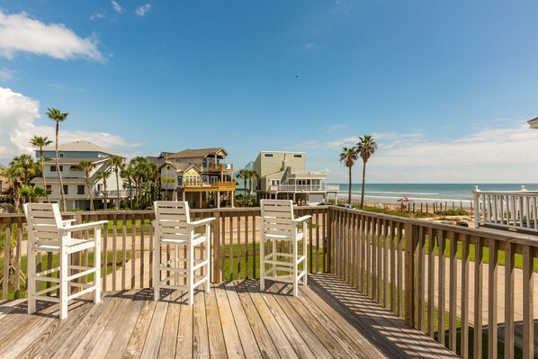 Relax on the beachfront deck with comfortable white chairs and take in the breathtaking ocean views.