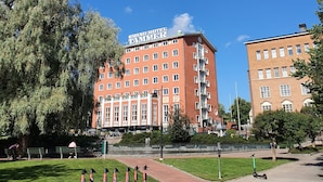 A large red building with a sign reading "GRAND HOTEL" and multiple windows. - 1BR Penthouse with Sauna & Private Rooftop Terrace (Tampere)