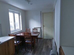 Enjoy meals in this cozy dining area with a table and chairs, a window, and a door leading to more space.