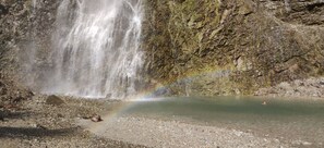 Surrounded by natural beauty, this serene pool features a waterfall cascading into its tranquil waters.