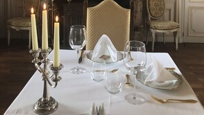 A formal dining room with a table set for four, a fireplace, ornate wall decorations, and a large mirror. - Great château close to Bourges  for 15 people (Blet)