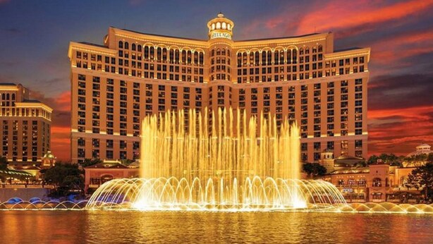 A large hotel with a prominent fountain in front. - Spacious 2-Bedroom Condo w/ Kitchen, Pool, 24/7 Free Shuttle to Strip (Las Vegas)