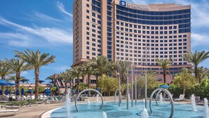 A Wyndham hotel with a large pool area featuring multiple water jets and lounge chairs. - Spacious 2-Bedroom Condo w/ Kitchen, Pool, 24/7 Free Shuttle to Strip (Las Vegas)