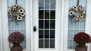 A house entrance with two doors, each adorned with a wreath and a flower pot. - ❤️ Romantic Couples Retreat in the country❤️Farm Stay  (Ephrata)
