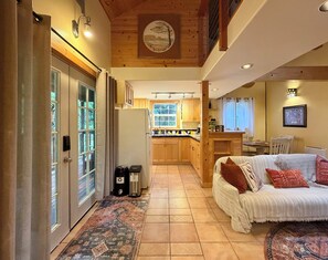 A cozy interior with a living area, kitchen, and a dining area.