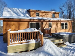 A wooden cabin with a covered porch and a hot tub. - Ace of Hearts. Secluded Hocking Hills cabin! (Rockbridge)