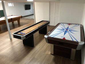 Enjoy games and entertainment in this room with two pool tables and a TV.