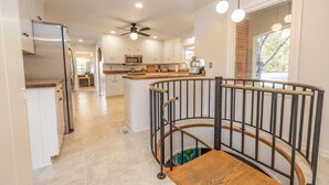 A modern kitchen with white cabinets, a central island, and a ceiling fan. - Amazing Views - Heated Pool - Hot Tub - Game Room - Enjoy! (Landrum)