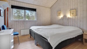 Ein Schlafzimmer mit einem Bett, einem Schreibtisch und einem Stuhl.