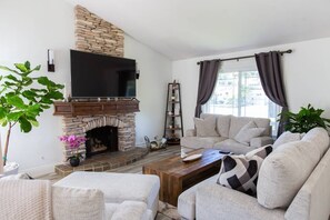 Smart TV, fireplace, books, computer monitors