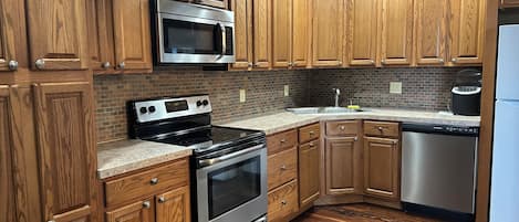 Microwave, dishwasher, coffee/tea maker, cookware/dishes/utensils