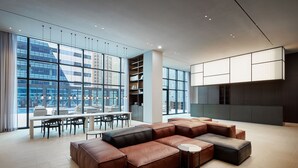 A spacious modern lounge with leather sofas, a dining area, and large windows offering city views. - Shilla Stay Seobusan (Busan)