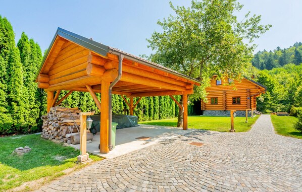 A wooden cabin with a covered porch and a stone pathway leading to it. - Gorgeous home in Brod Na Kupi with sauna (Brod Na Kupi)