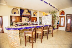 Enjoy casual dining or working in this kitchen with a central island, wooden cabinets, and an oven.