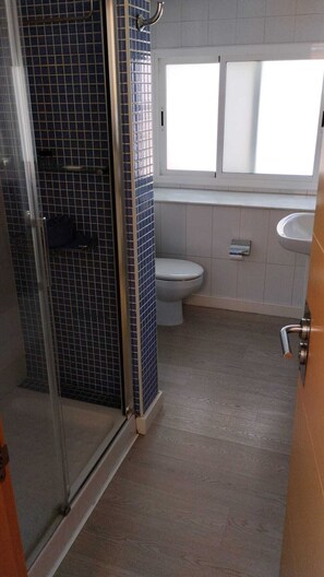 Shower, hair dryer, towels, toilet paper