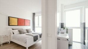 A modern bedroom with a white bed, bedside tables, and a large window. - MARK'S GALLERY - By MyHomeInComo (Como)