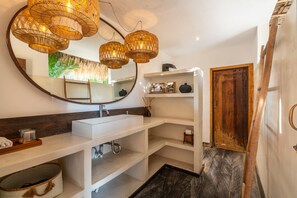A modern bathroom with a large mirror, white shelves, a white sink, and a wooden door. - Fabulous 3BR Boho-chic Style, Umalas With Staff (Kerobokan)