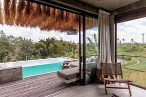 A modern room with a large window, a view of a swimming pool, and a wooden deck. - Batukaru Private Pool Suite 3 (Canggu)
