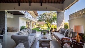 A modern outdoor living area with a sofa, armchairs, and a coffee table. - Peaceful Private Villa, 3 BR, Canggu With Staff (Canggu)