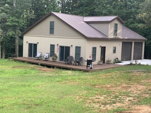 Relax on the front porch with comfortable seating and a small table.