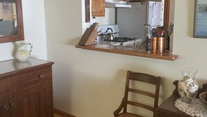 A kitchen with wooden cabinets, a stove, and a sink.