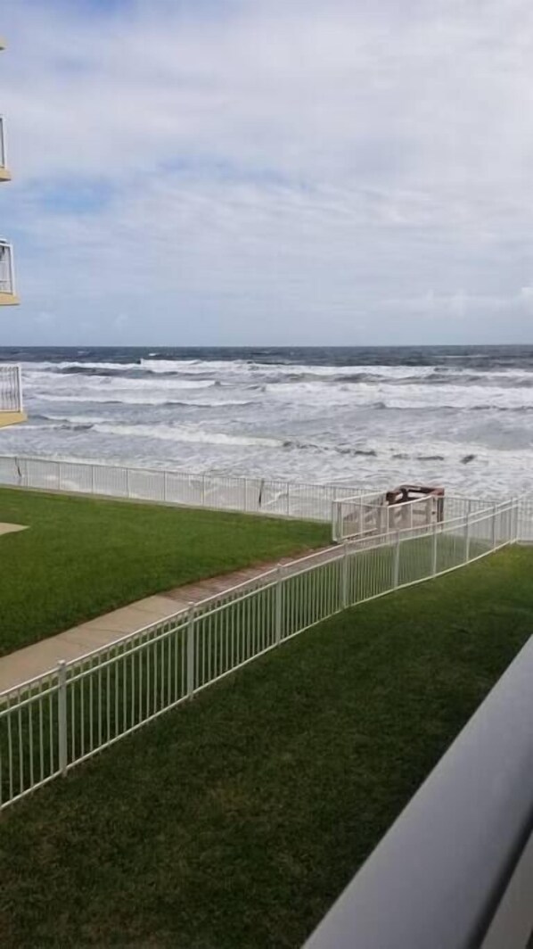 Enjoy the dramatic ocean views from this balcony with a seating area.