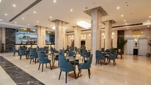 A spacious hotel lobby with multiple seating areas, marble flooring, and modern lighting fixtures. - Sphinx Aqua Park Beach Resort (Hurghada)