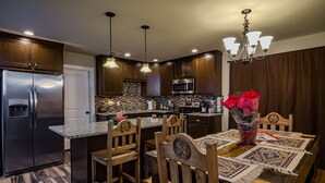 A modern kitchen with wooden cabinets, stainless steel appliances, and a central island.