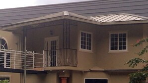 A two-story building with a balcony on the upper floor.