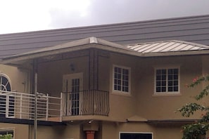 A two-story building with a balcony on the upper floor.