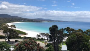 A coastal landscape with a beach, trees, and a clear sky. - MOONRISE BINALONG BAY Stunning views  (Binalong Bay)