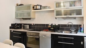 A modern kitchen with stainless steel appliances, a dishwasher, and a microwave. There are cabinets above the countertop and a sink with a faucet. - 3 bedroom accommodation in Alnwick (Alnwick)