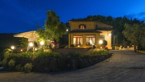 A two-story house with a paved driveway and a stone wall. - Villa with Pool in Tuscany for 8 People (Cantagrillo)