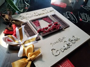 A gift box with a ribbon and a card that reads "Le Châteaulin." - HOT TUB, Parking, A/C - Near SeaWorld, Beaches, MCRD, Barnes Tennis, PLNU! (San Diego)