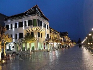 A multi-story building with a modern design, featuring large windows and a flat roof. - White City (Berat)