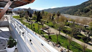 A balcony with a view of a park, a river, and distant mountains. - White City (Berat)
