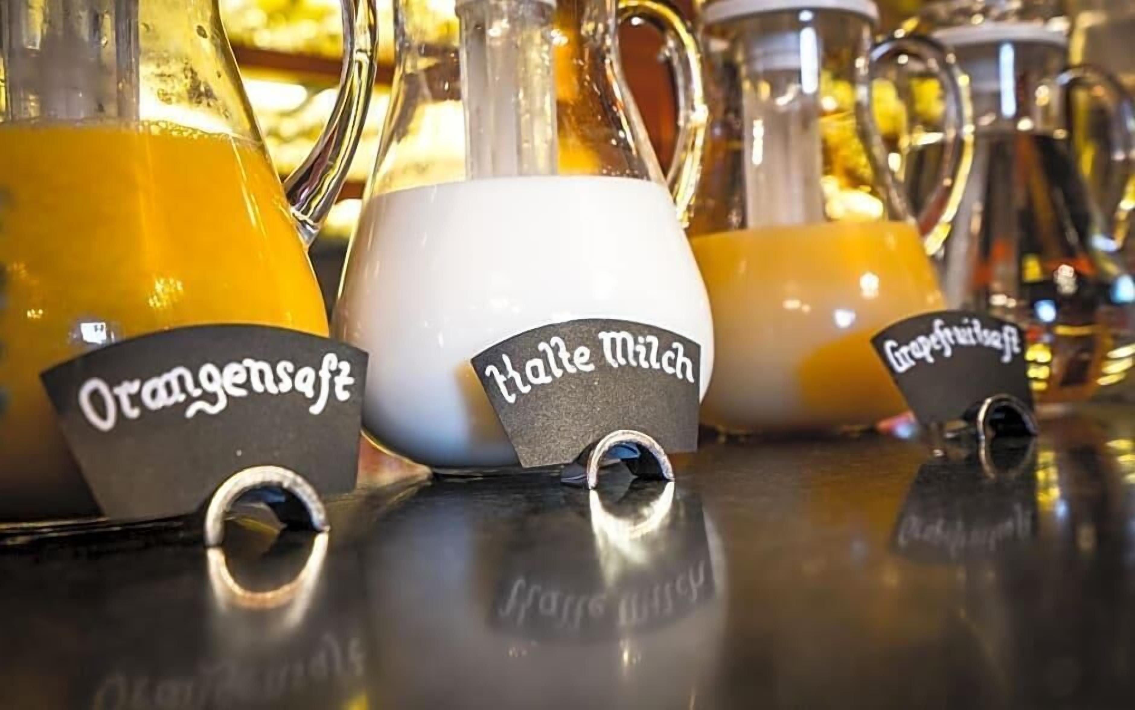 A selection of beverage dispensers with labels indicating different types of drinks.